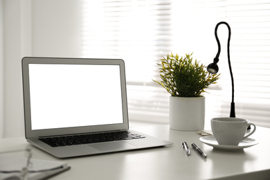 Modern laptop on office table. Stylish workplace