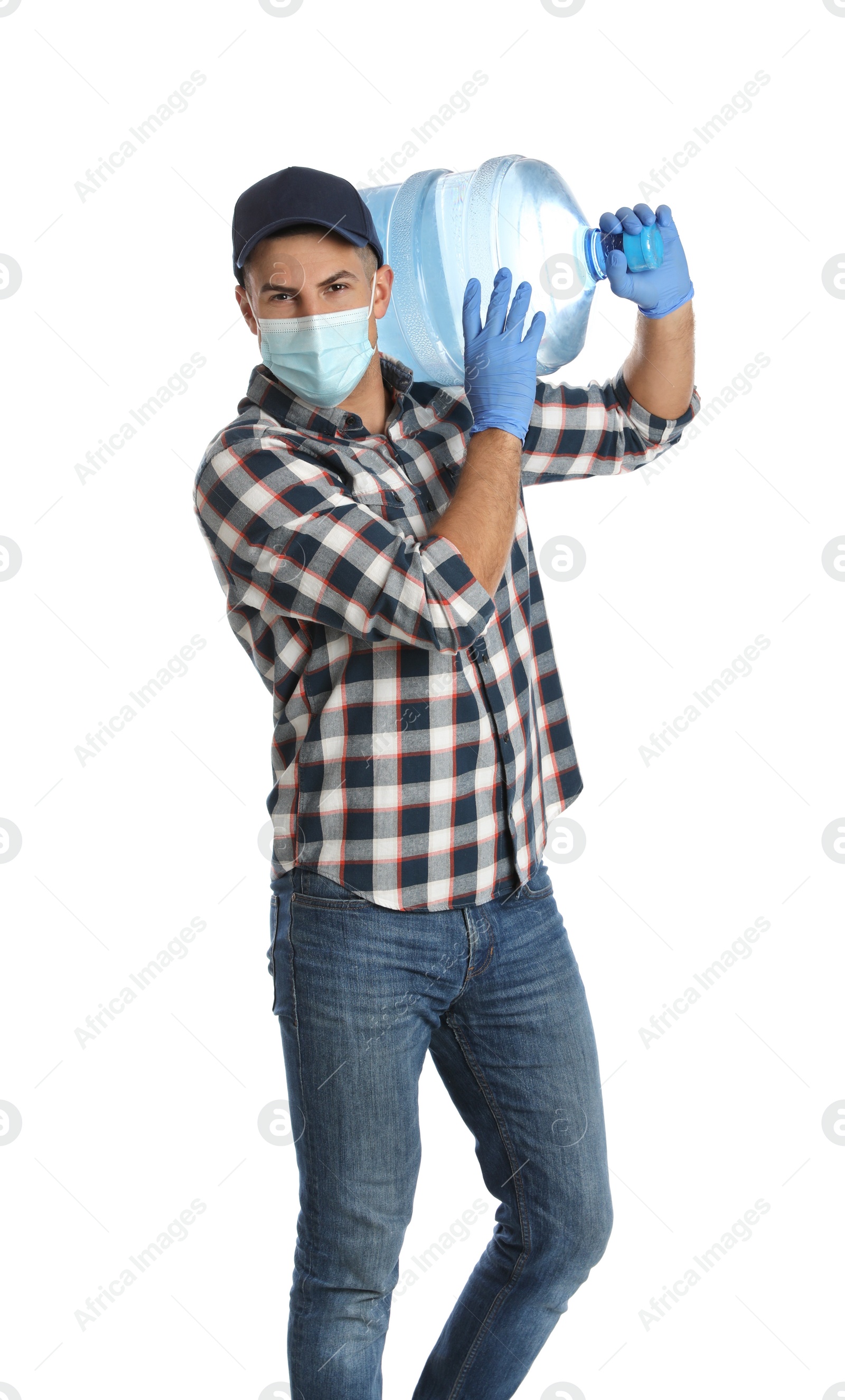 Photo of Courier in face mask with bottle of cooler water on white background. Delivery during coronavirus quarantine