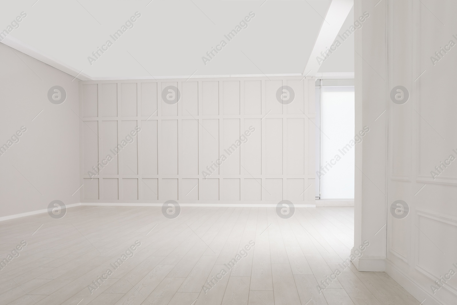 Photo of Empty room with beige walls and laminated flooring
