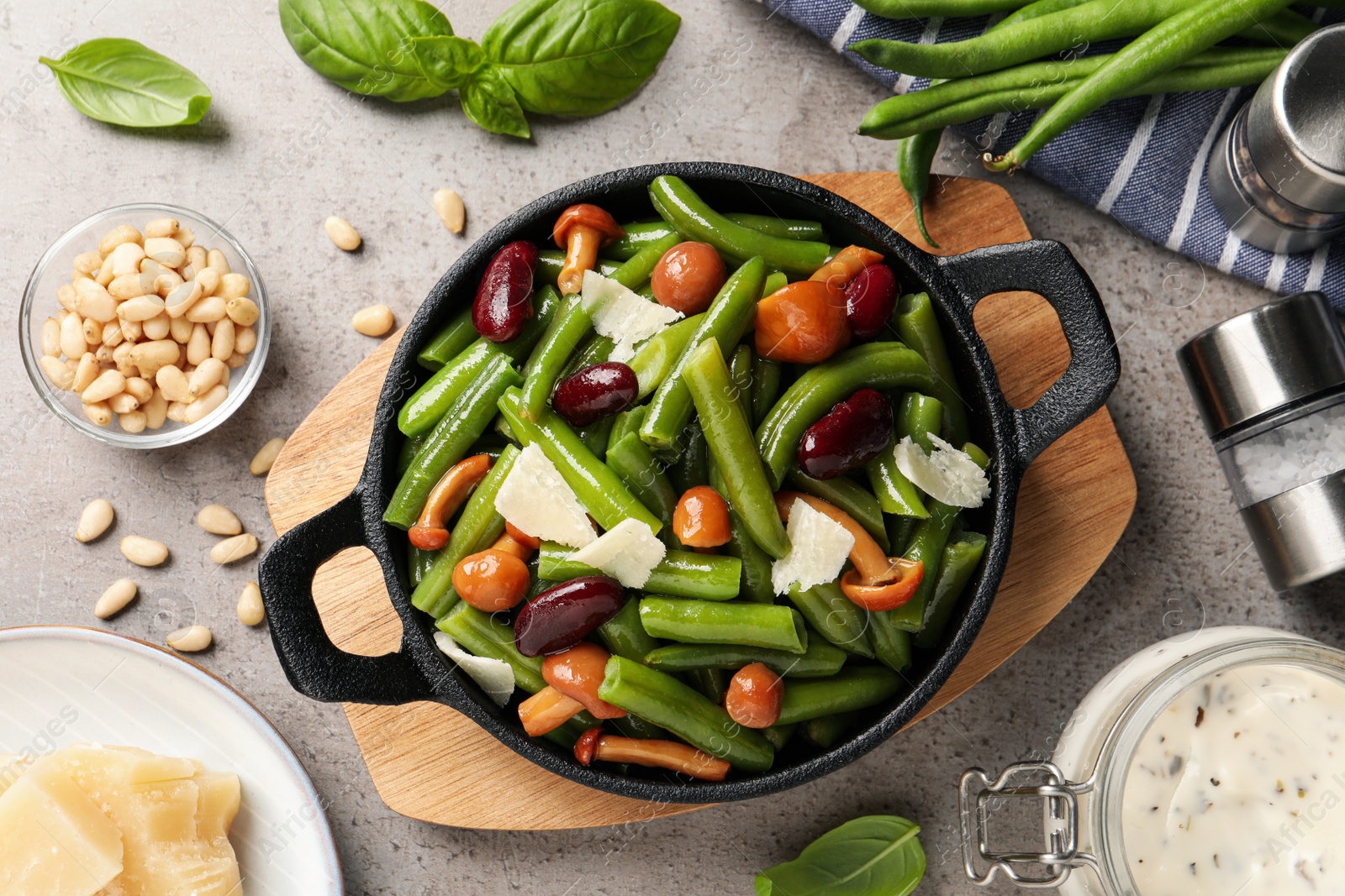 Photo of Delicious salad with green beans, mushrooms and cheese on light grey table, flat lay