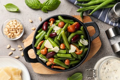 Delicious salad with green beans, mushrooms and cheese on light grey table, flat lay