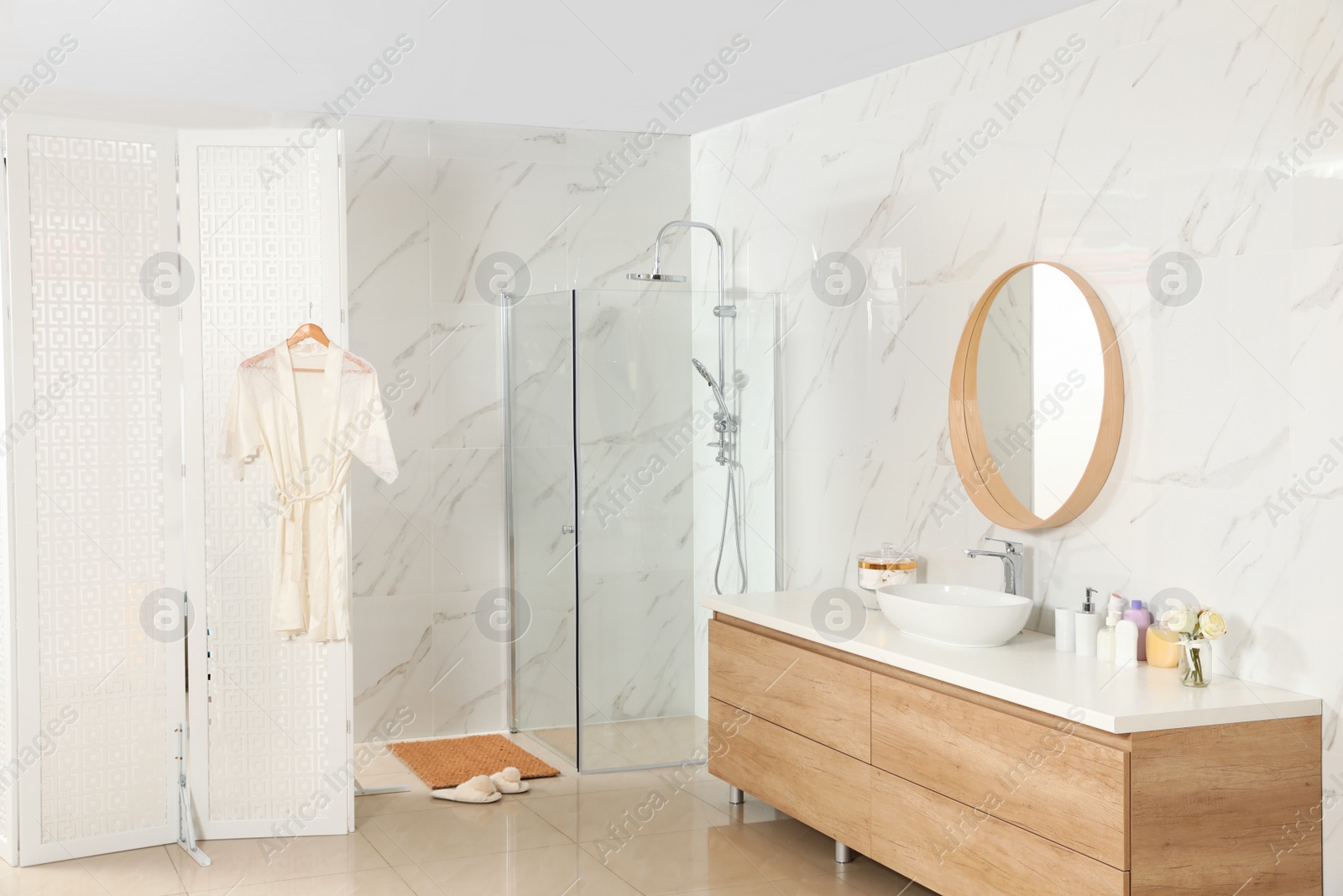 Photo of Modern bathroom interior with shower stall and folding screen