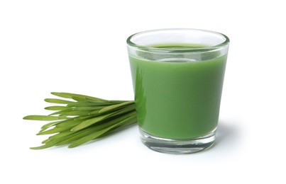 Photo of Glass of fresh wheat grass juice and sprouts on white background