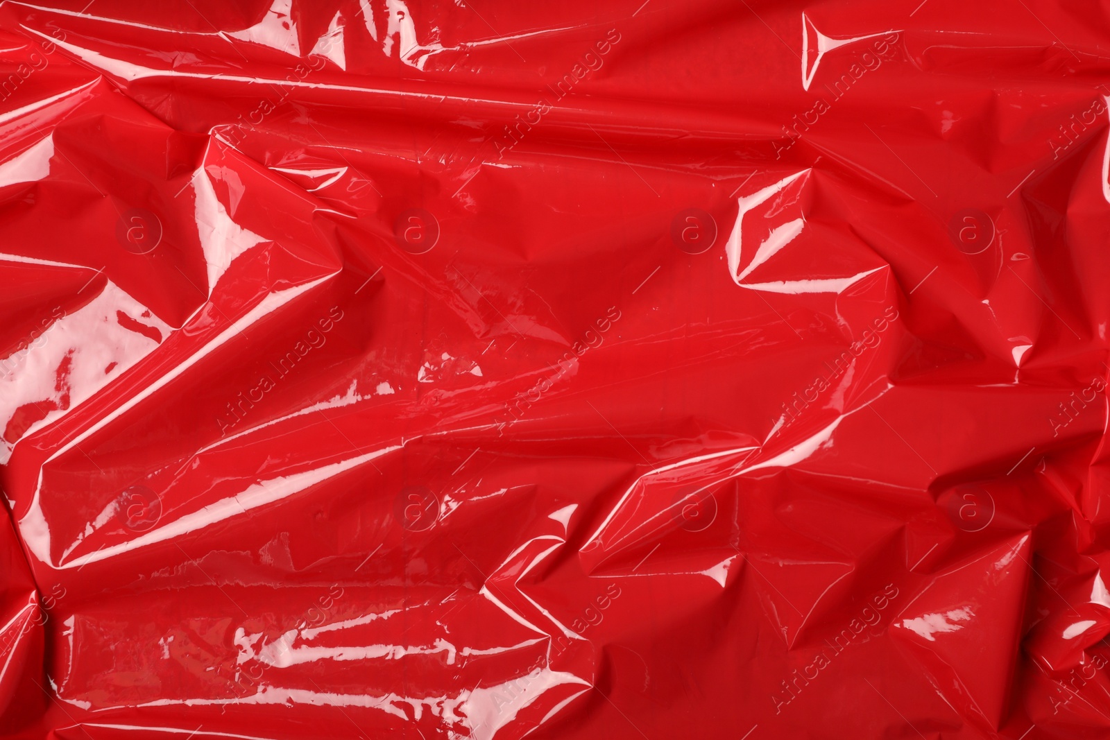 Photo of Red plastic stretch wrap as background, top view