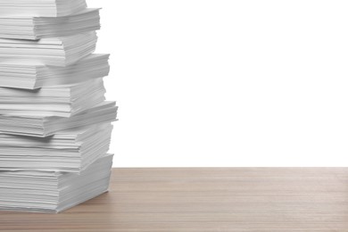 Photo of Stack of paper sheets on wooden table against white background. Space for text