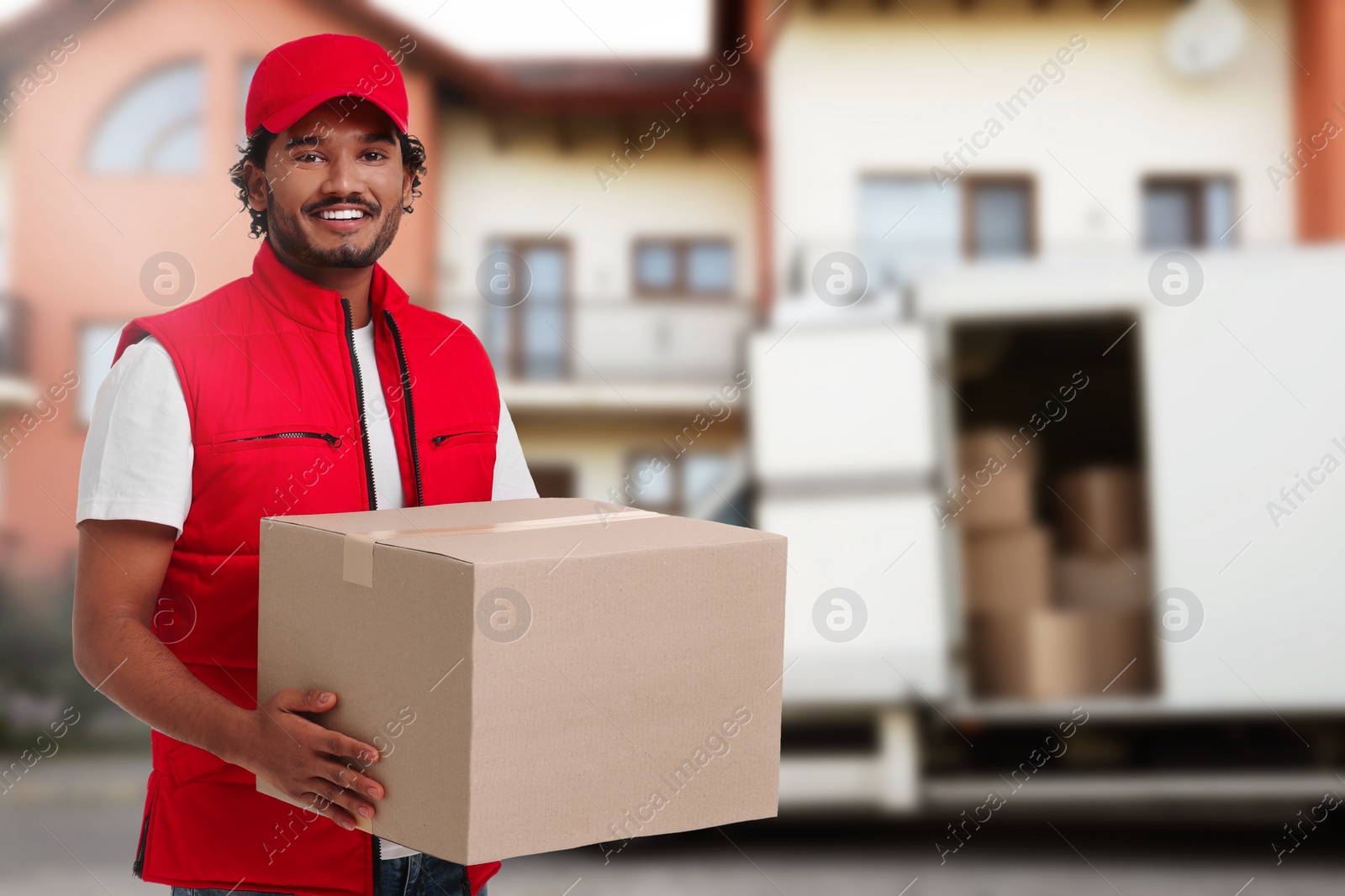 Image of Happy courier with parcel outdoors, space for text