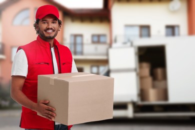 Image of Happy courier with parcel outdoors, space for text