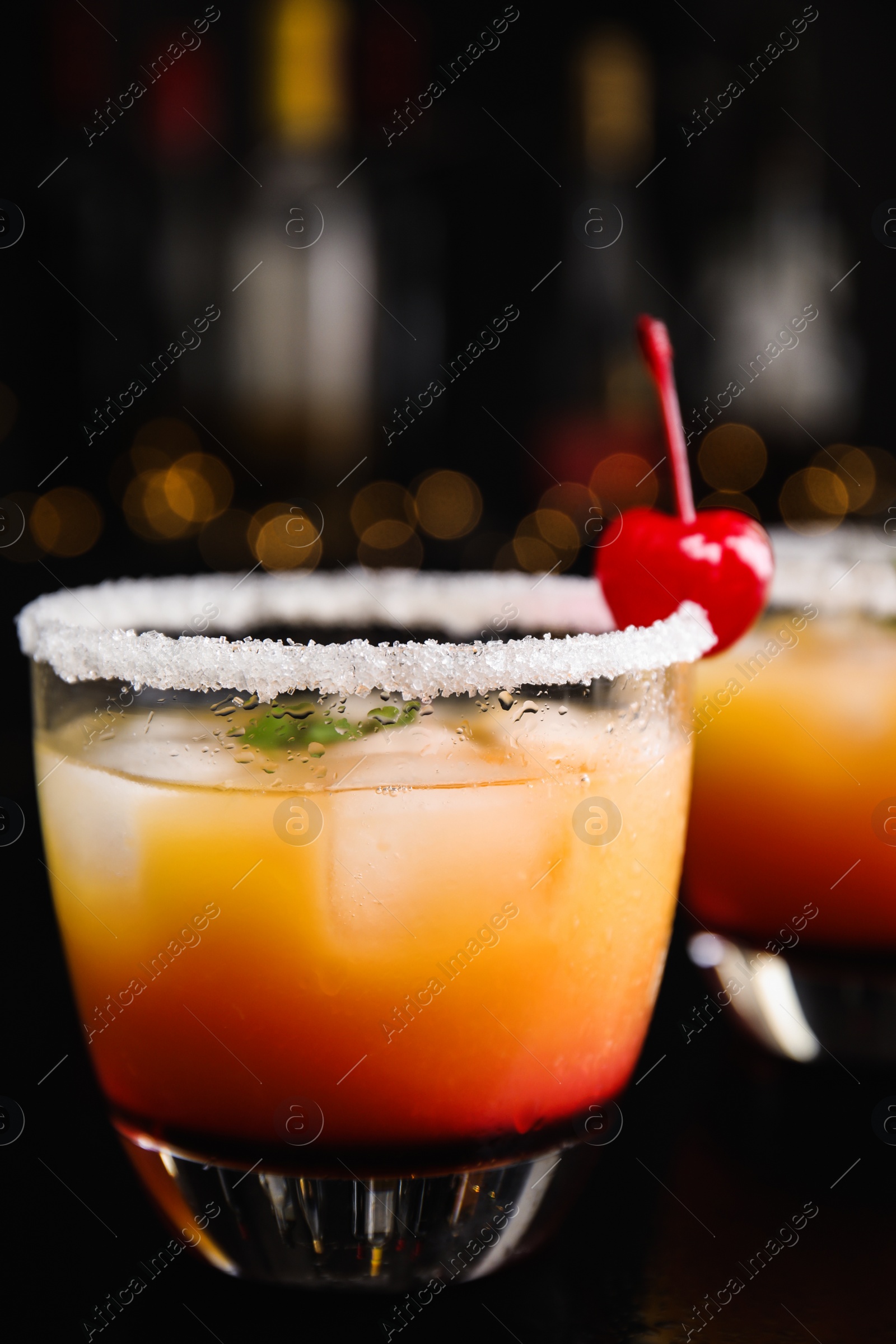 Photo of Fresh alcoholic Tequila Sunrise cocktail on black table
