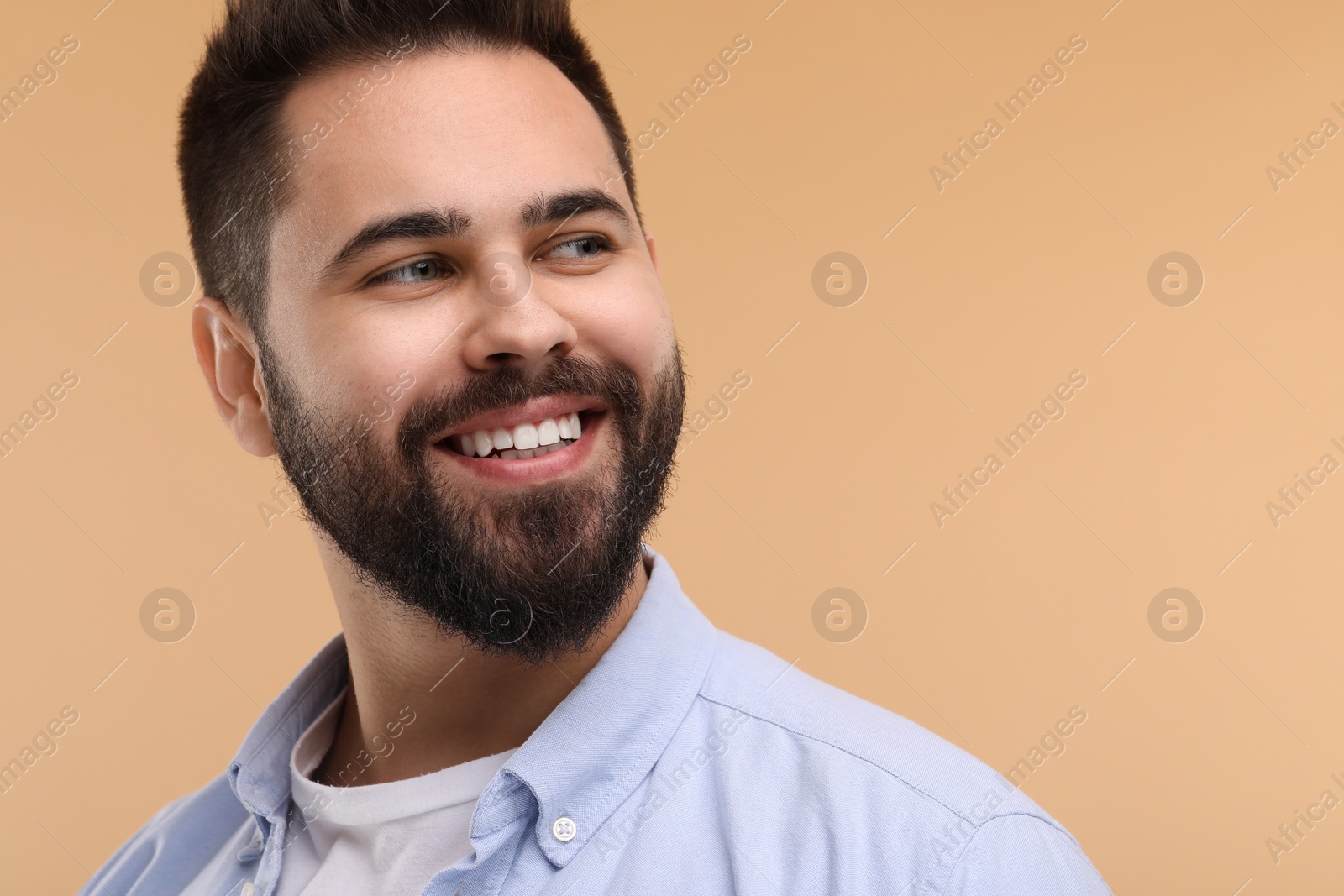 Photo of Man with clean teeth smiling on beige background, space for text