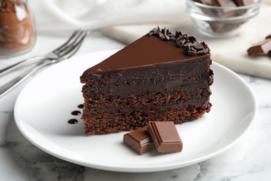 Delicious fresh chocolate cake served on white marble table