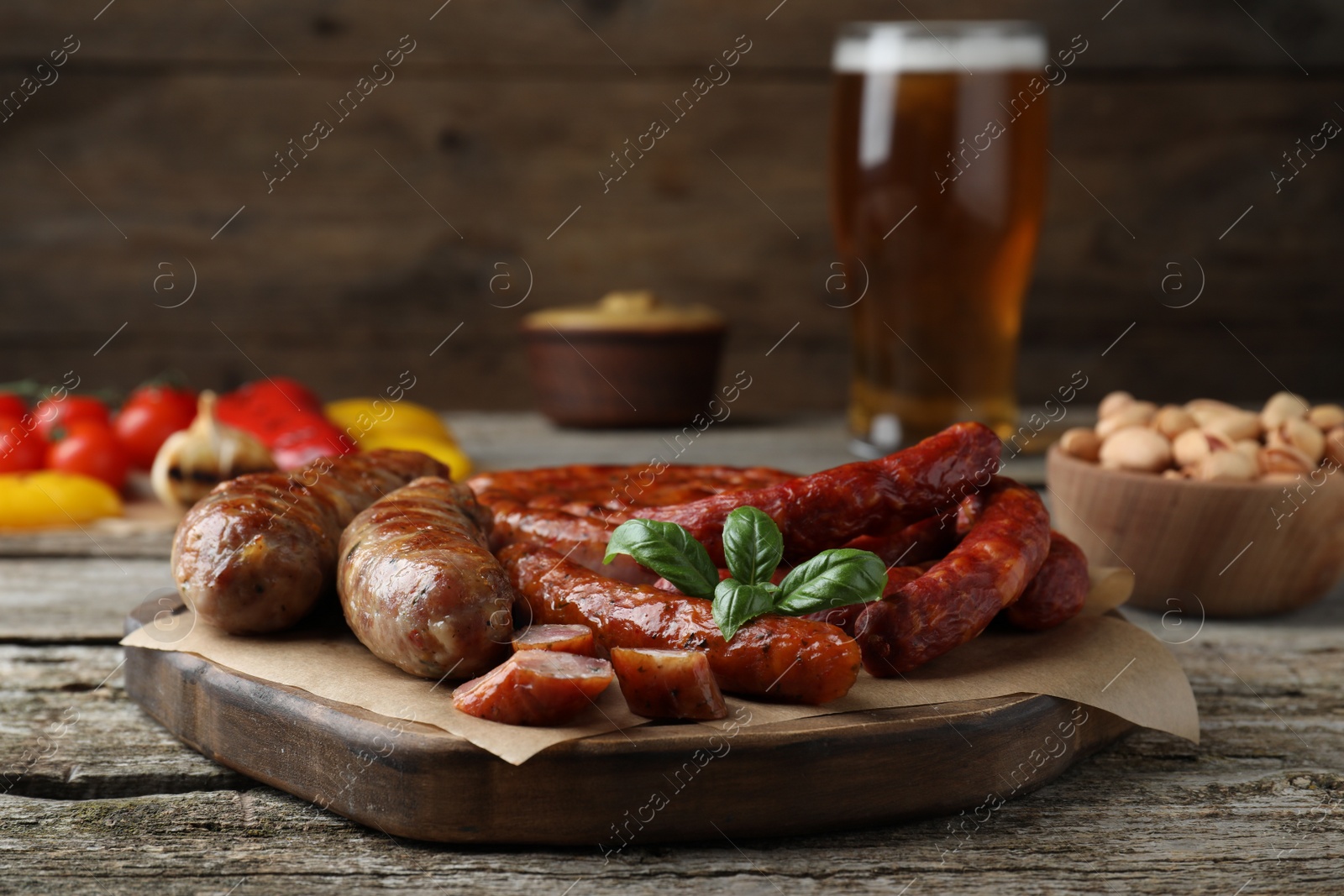 Photo of Set of different tasty snacks on wooden table, closeup view
