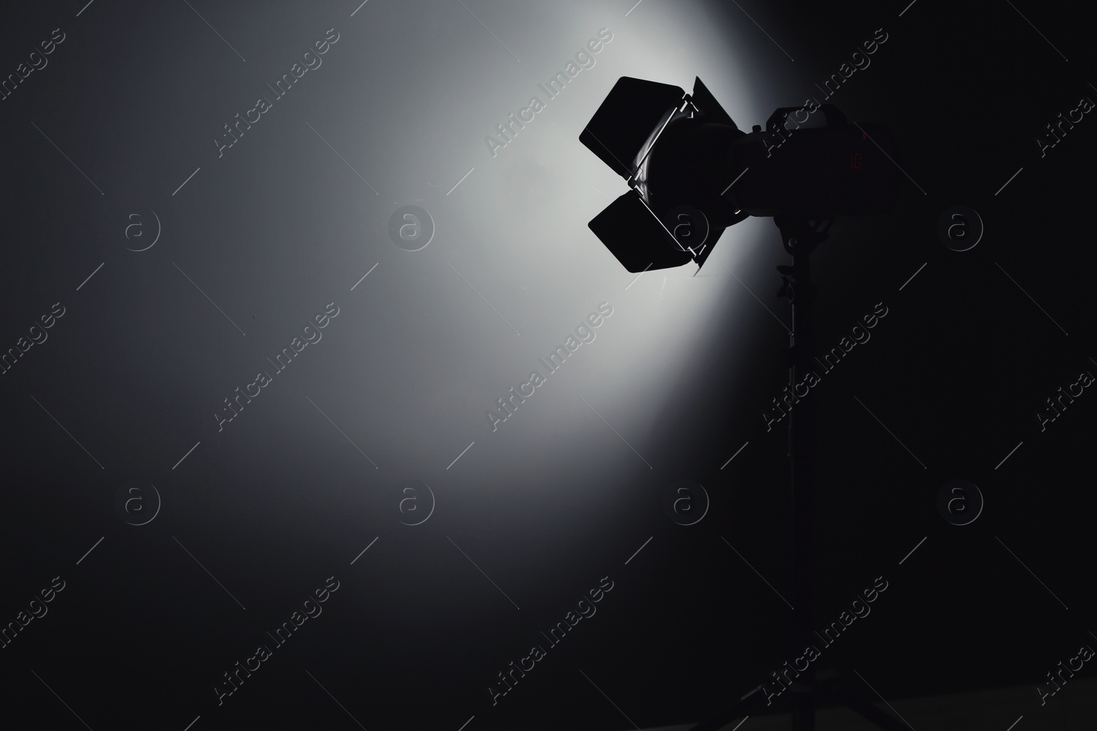 Photo of Professional photo studio lighting equipment on dark background. Space for text