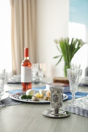 Photo of Table served for Passover (Pesach) Seder indoors, space for text
