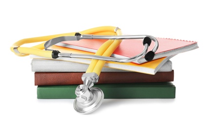 Stethoscope and notebooks on white background. Medical students stuff