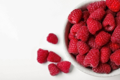 Photo of Top view of bowl with delicious ripe raspberries on white background, closeup