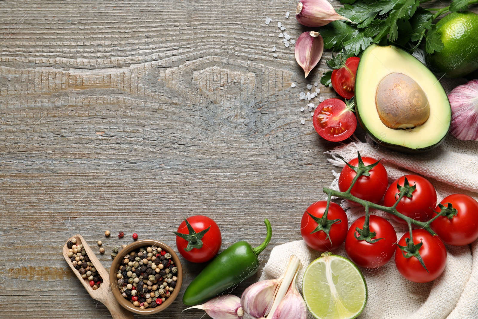 Photo of Fresh guacamole ingredients on wooden table, flat lay. Space for text