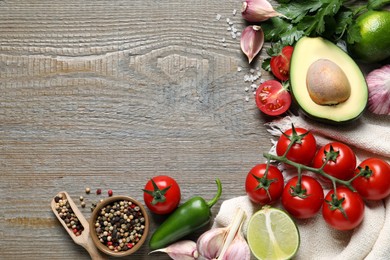 Fresh guacamole ingredients on wooden table, flat lay. Space for text