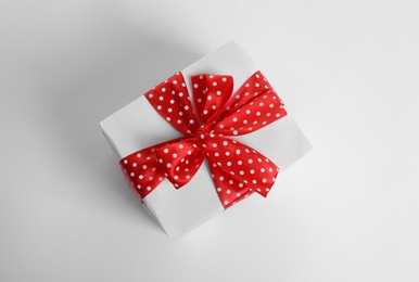 Photo of Beautifully wrapped gift box on white background, top view