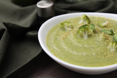 Photo of Delicious broccoli cream soup on table, closeup