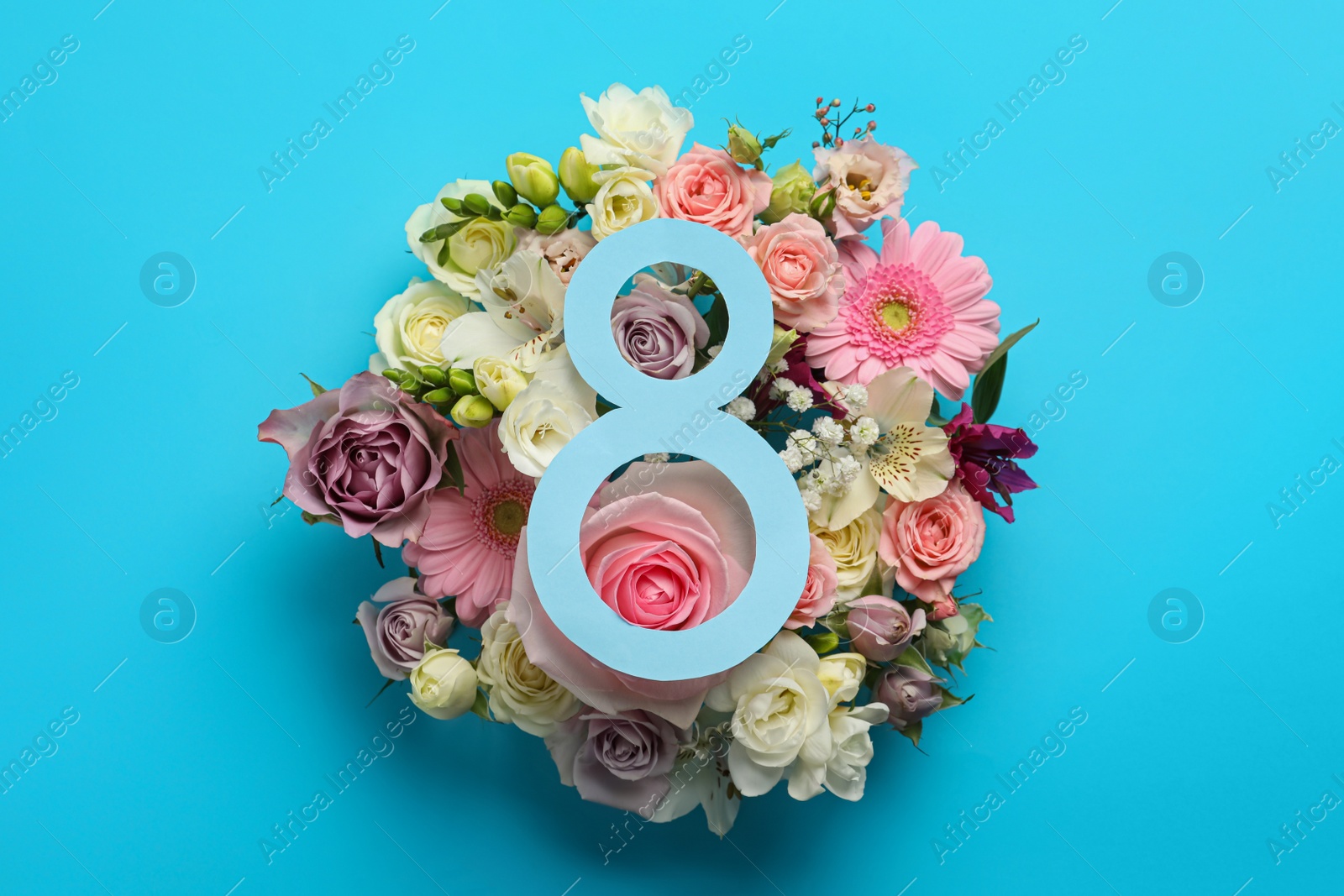 Photo of 8 March greeting card design with beautiful flowers on light blue background, flat lay. International Women's day