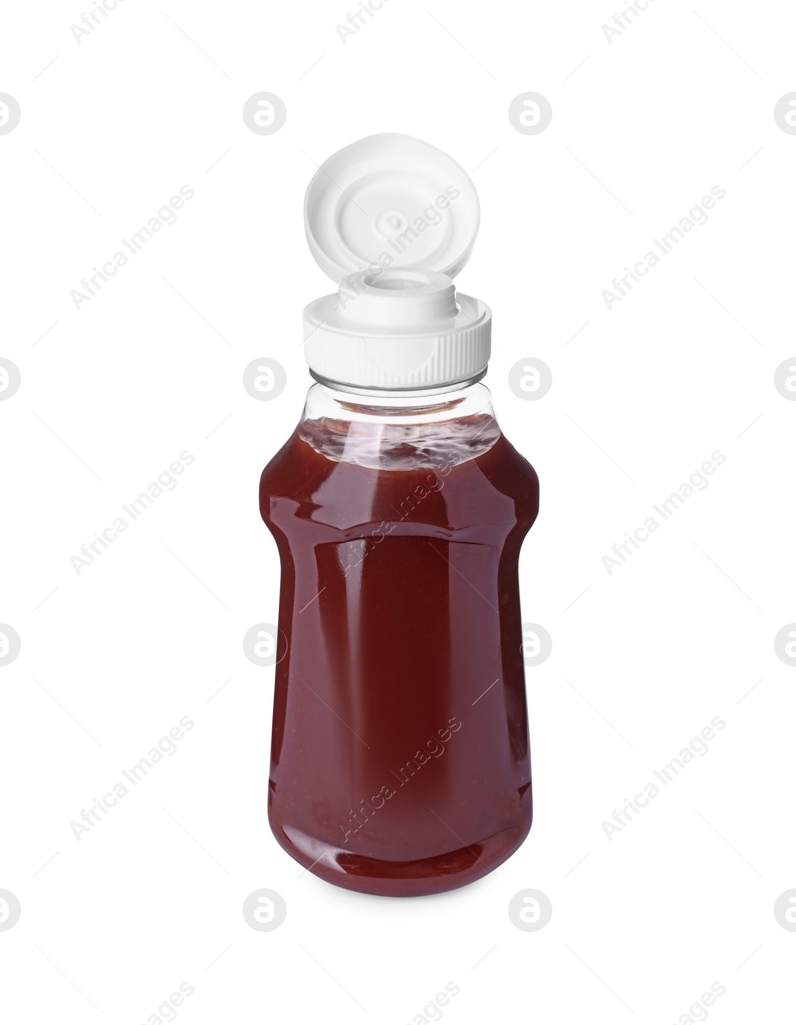 Photo of Bottle of tasty ketchup isolated on white