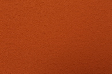 Orange textured surface as background, closeup view