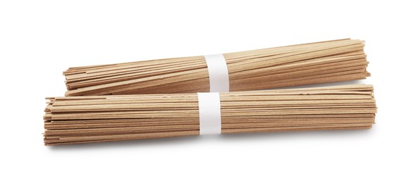 Photo of Uncooked buckwheat noodles (soba) isolated on white