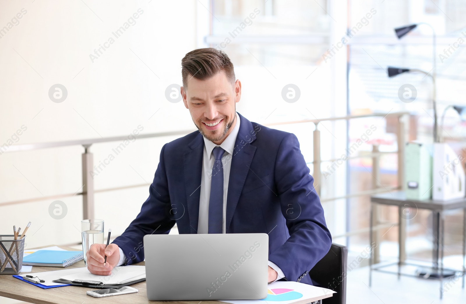 Photo of Consultant working at table in office