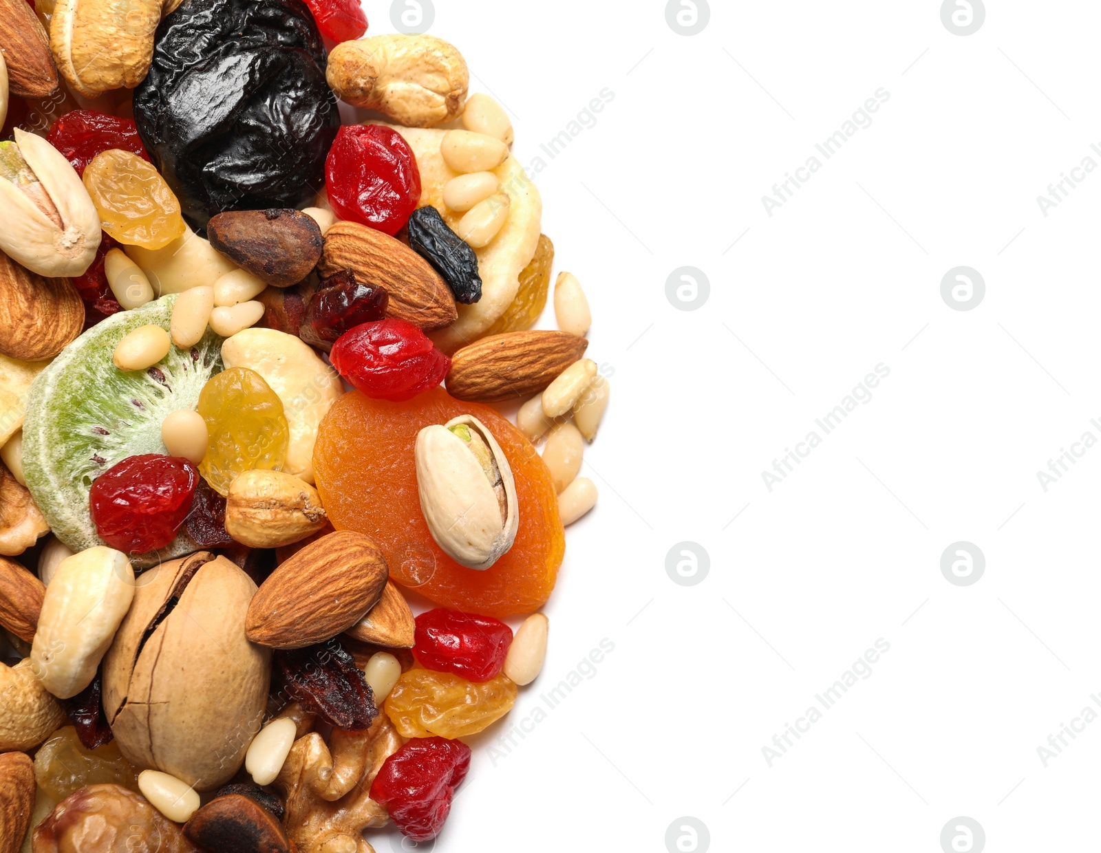 Photo of Different dried fruits and nuts on white background, closeup. Space for text