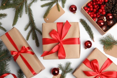 Composition with gift boxes and Christmas decor on white background, flat lay