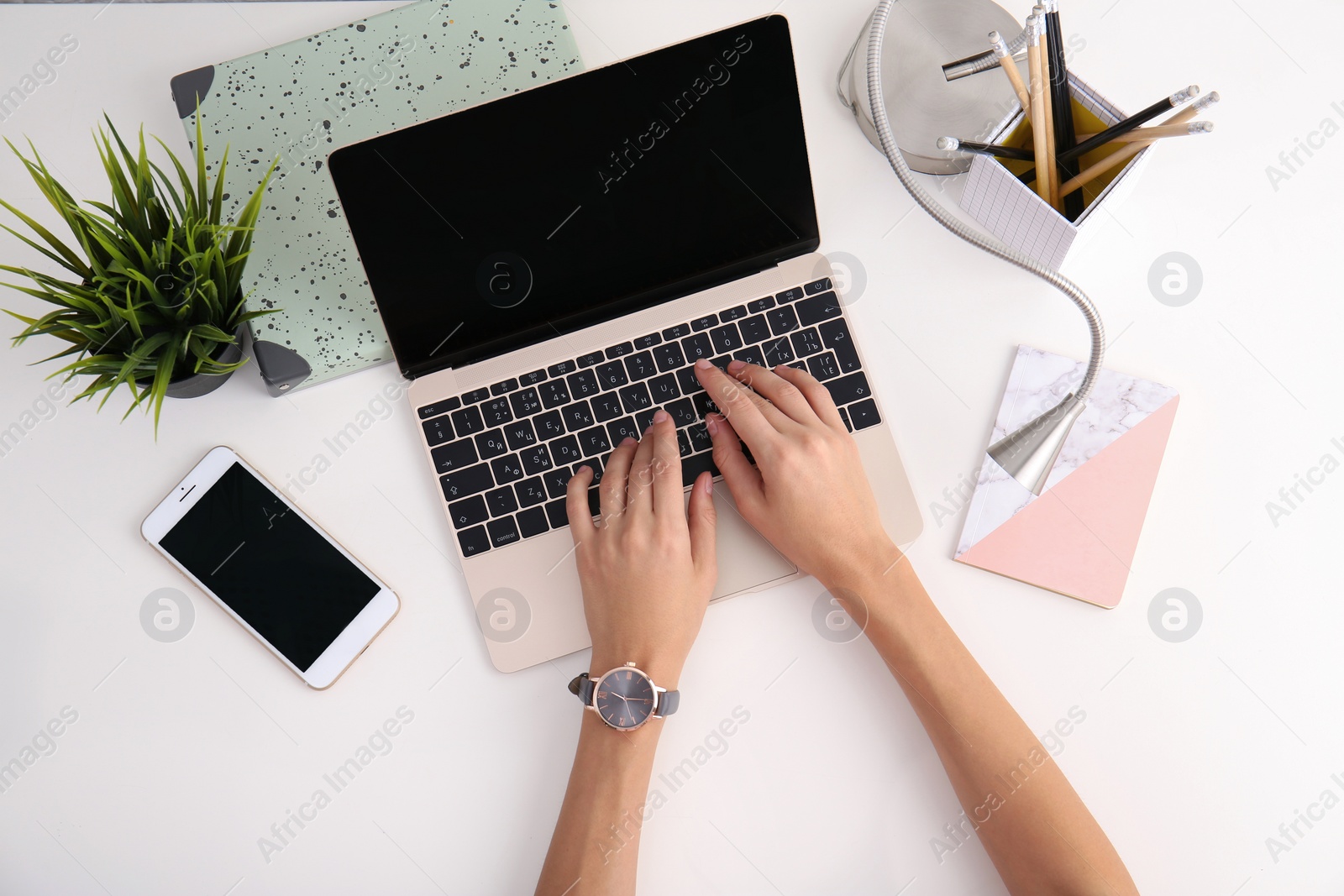 Photo of Woman working with laptop at table, top view. Mockup for design