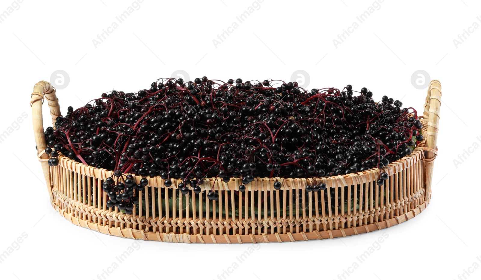 Photo of Wicker basket with ripe elderberries isolated on white