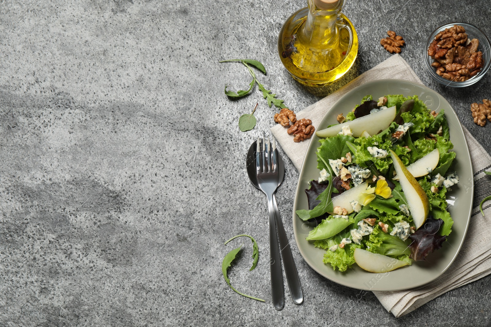 Photo of Fresh salad with pear served on grey table, flat lay. Space for text