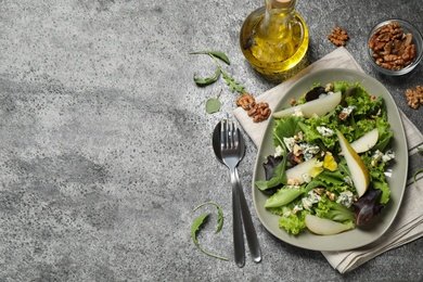 Fresh salad with pear served on grey table, flat lay. Space for text