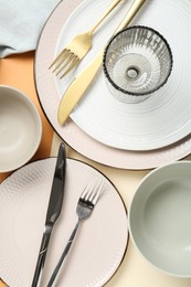 Photo of Clean plates, bowls, glass and cutlery on table, flat lay