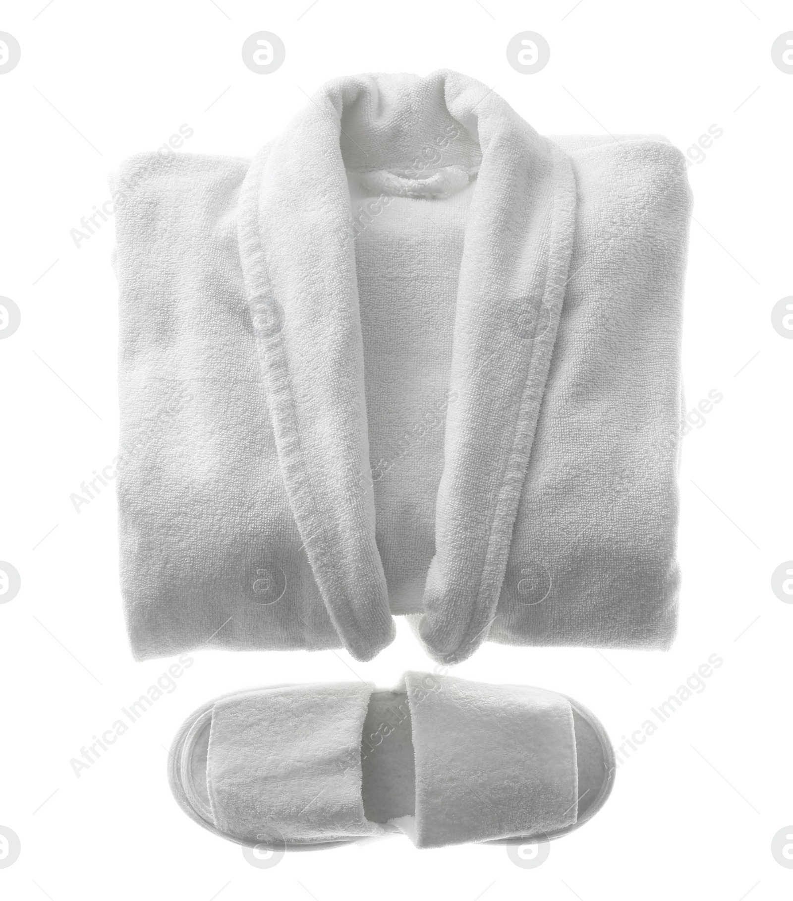 Photo of Clean folded bathrobe and slippers isolated on white, top view