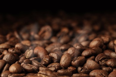 Heap of aromatic roasted coffee beans, closeup