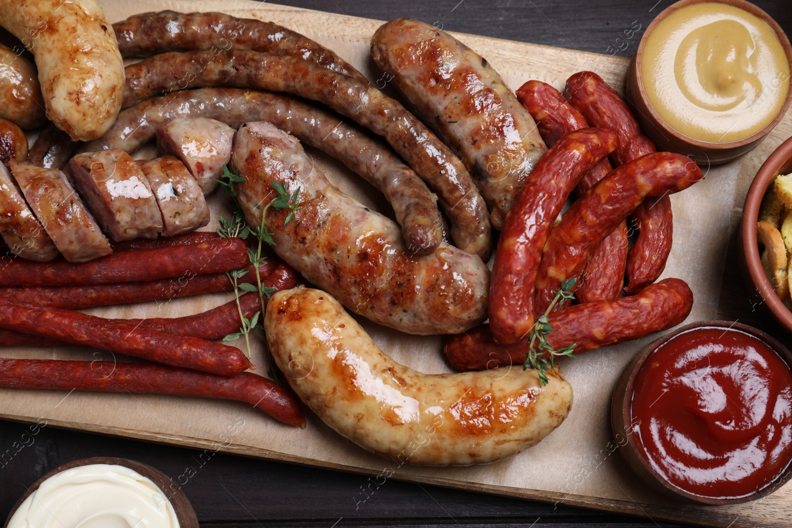 Photo of Set of different tasty snacks on wooden table, top view