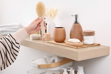 Photo of Bath accessories. Woman with brush indoors, closeup