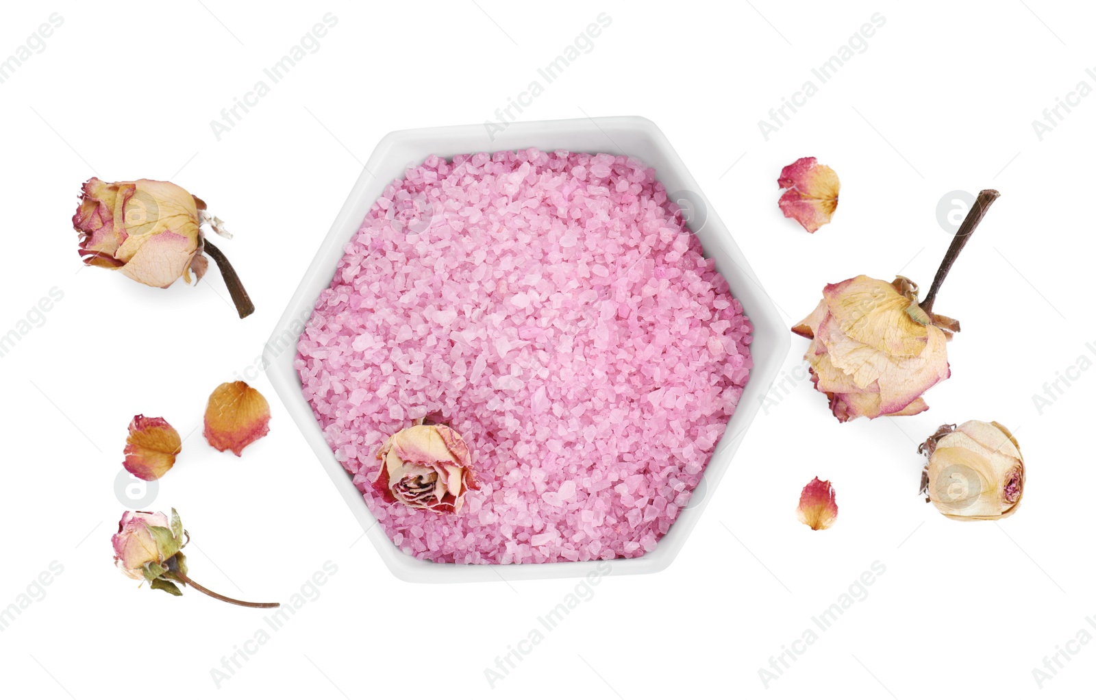 Photo of Bowl of pink sea salt and dry rose flowers isolated on white, top view