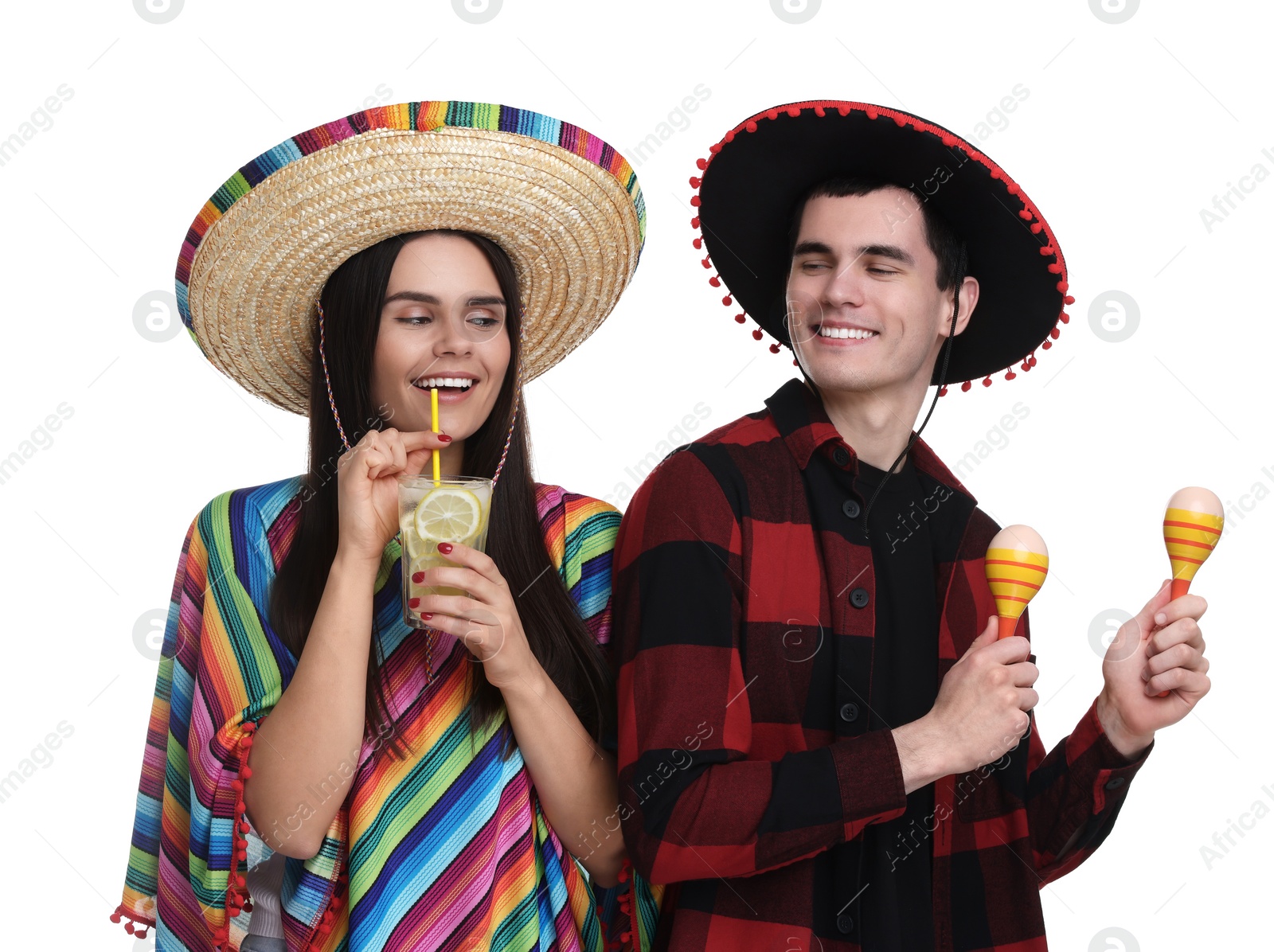 Photo of Lovely couple in Mexican sombrero hats with cocktail and maracas on white background