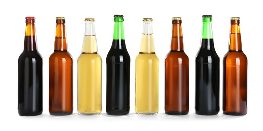 Photo of Bottles with different beer on white background