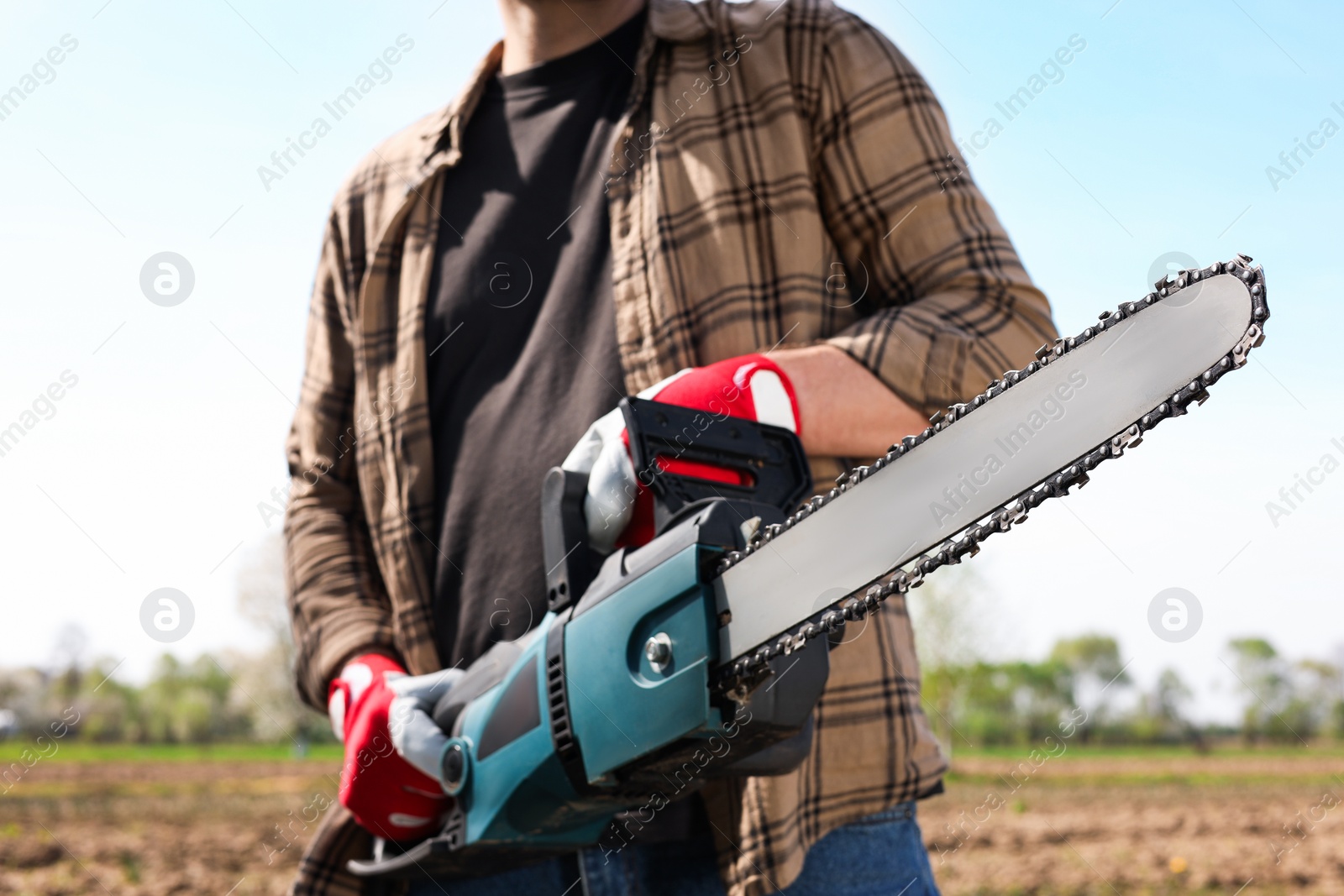 Photo of Man with modern saw on sunny day, closeup