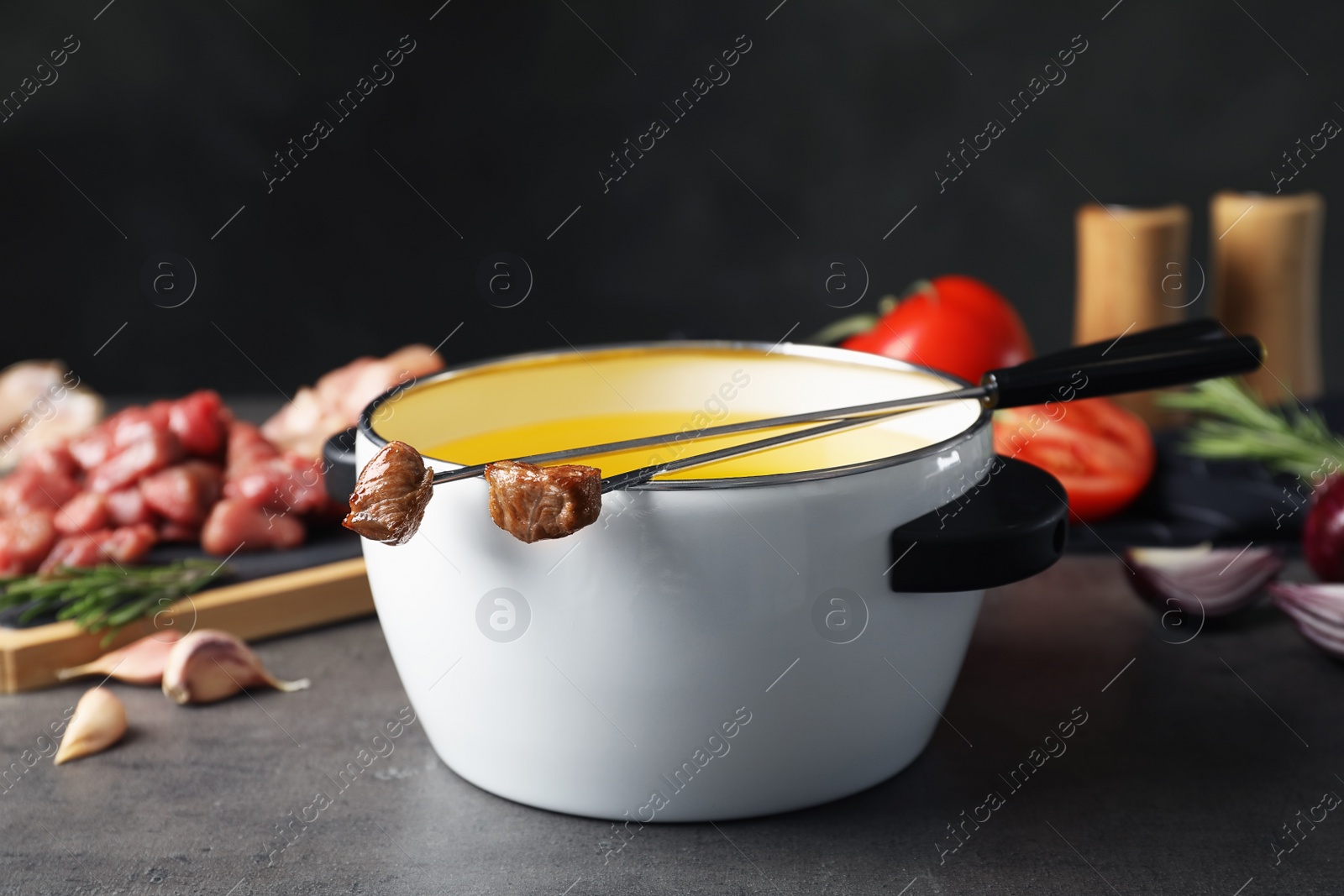 Photo of Composition with fondue pot on table against blurred background