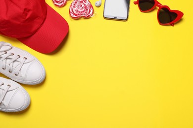 Photo of Flat lay composition with modern clothes and accessories on yellow background. Space for text