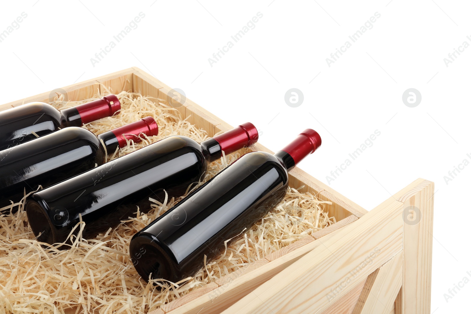 Photo of Bottles of wine in open wooden crate isolated on white