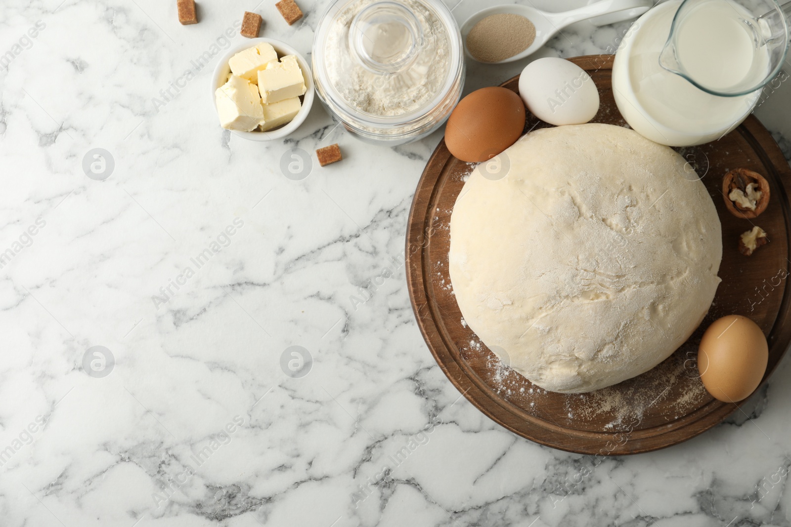 Photo of Flat lay composition with dough for pastries on white marble table. Space for text