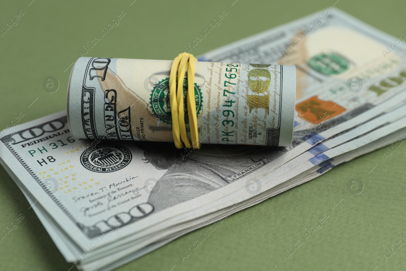 Photo of Money exchange. Dollar banknotes on green background, closeup