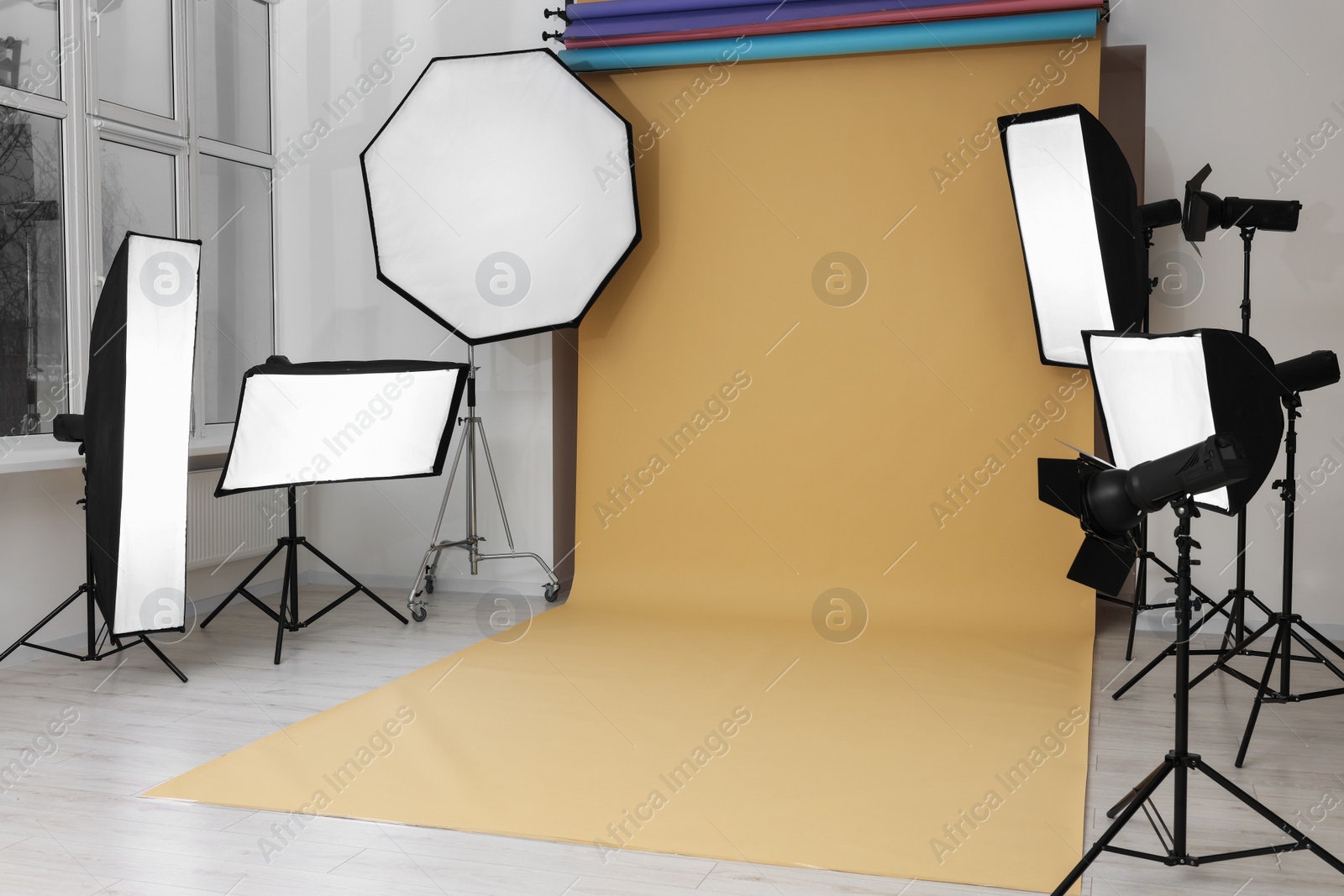 Photo of Interior of modern photo studio with professional lighting equipment