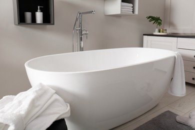 Photo of Stylish bathroom interior with modern white tub